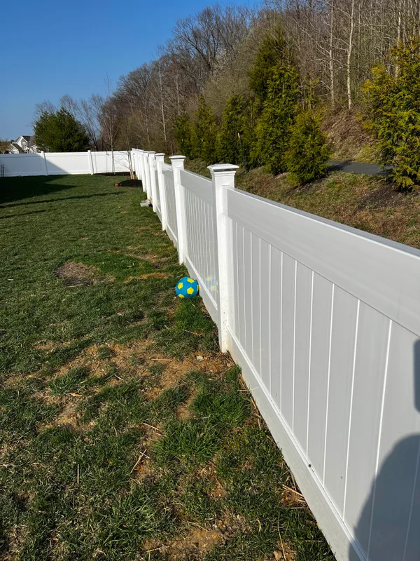 Vinyl privacy fence on hillside