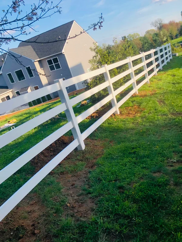 Vinyl ranch rail fence near house