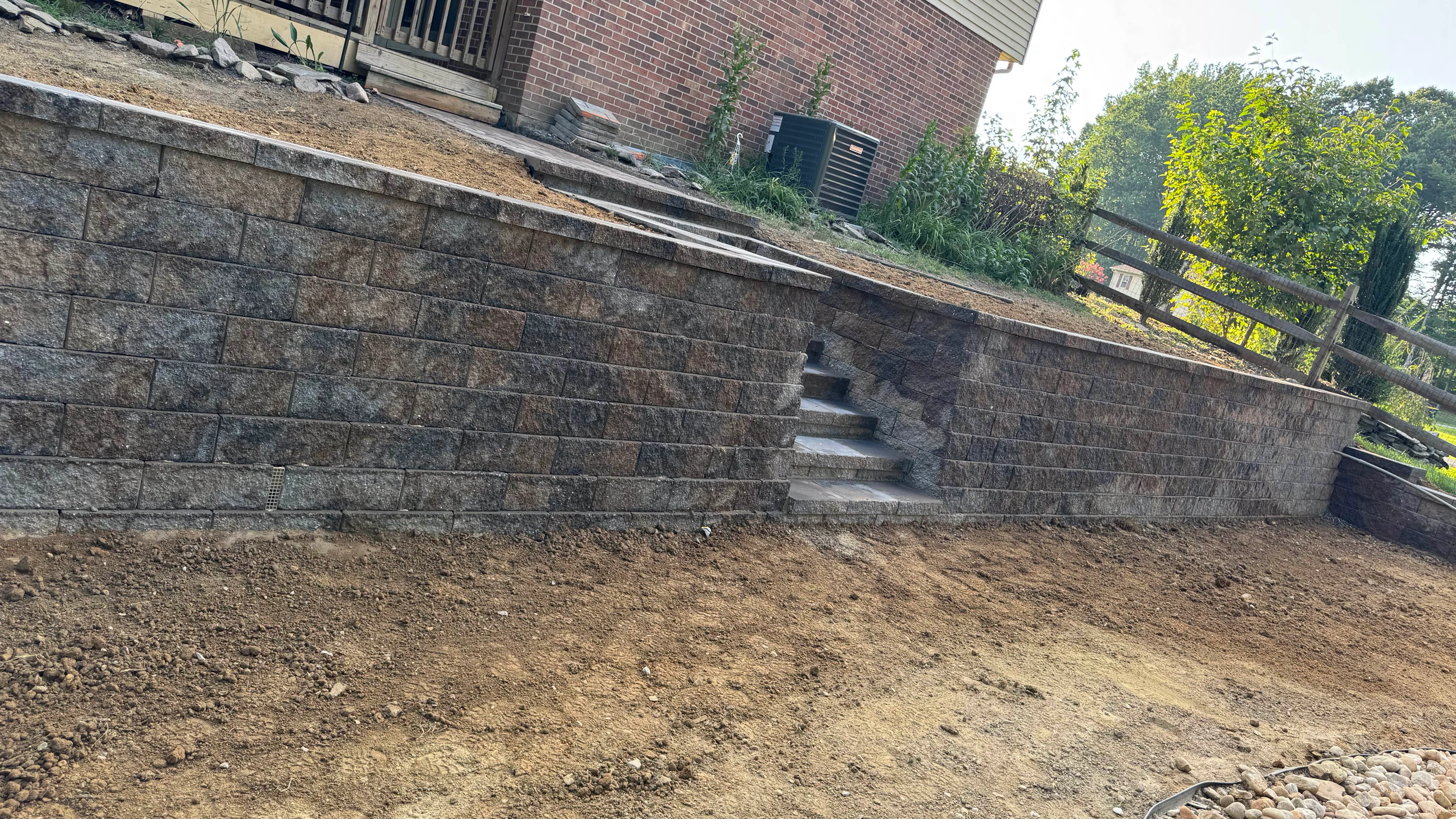 Retaining Walls featuring integrated steps with segmental wall block in Newark, Delaware