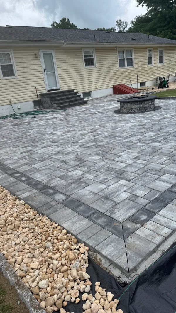 Patios featuring integrated steps and a built-in fire pit with paver finish in Newark, Delaware