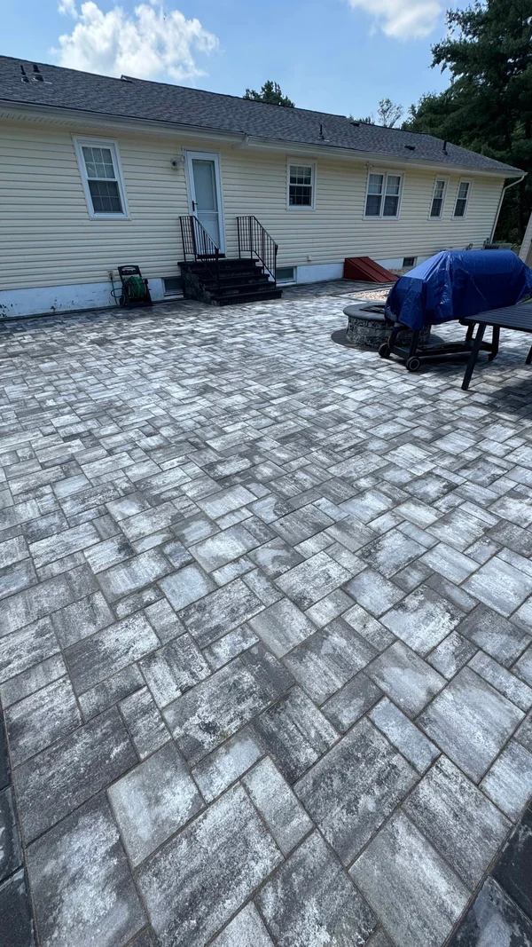 A paver patio with integrated steps and fire pit
